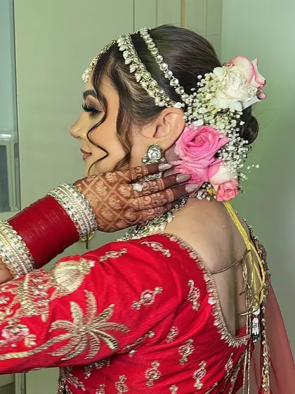 A side profile of my bride Payal, showcasing her intricate floral hair bun. Adding fresh flowers to the hair is a beautiful way to complete the bridal look and add a touch of softness.