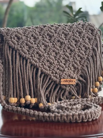My boho-style fringed sling bag is one of my most popular designs. I make it with soft, eco-friendly cotton cord, and it's perfect for adding a touch of handmade charm to any outfit. This beautiful brown shade is a classic.