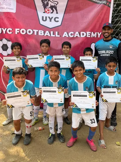 Our U-9 team proudly holding their participation certificates at the UYC Championship.