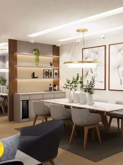 A sophisticated dining area featuring a built-in crockery unit with a wine cooler. The space is defined by a large mirror, statement pendant lighting, and elegant artwork, perfect for hosting and family meals.