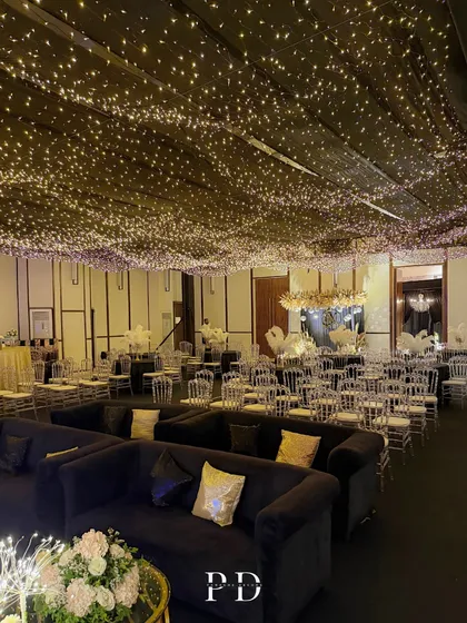 The full view of our 'Night Under The Stars' Sangeet setup. A ceiling canopy of thousands of fairy lights creates the illusion of a starry sky indoors, perfect for a glamorous and romantic evening.