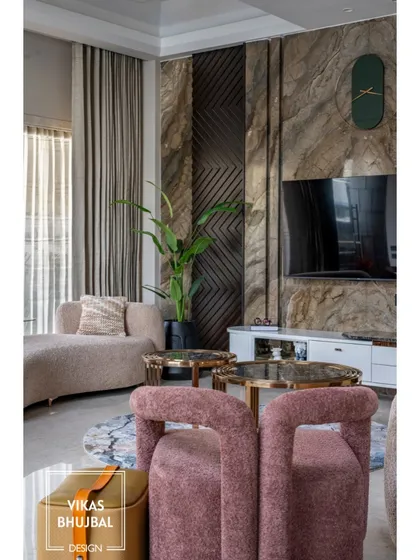 This living room corner uses a mix of textures and soft colors to create a cozy yet chic seating area. The natural stone wall and curved furniture add layers of visual interest.