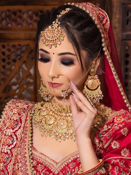 A close-up of a traditional red bridal look with bold, smokey eyes and perfectly defined lips, created by a student during their 45-day makeup course.