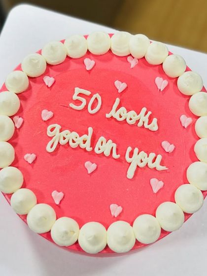 "50 looks good on you." A simple, chic, and minimalist bento cake that makes a sweet statement for a milestone birthday.