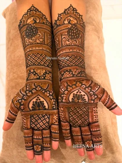 This bride requested a classic design with a modern feel. I used traditional peacock and lotus motifs but arranged them in a contemporary layout with lots of detailed pattern work.