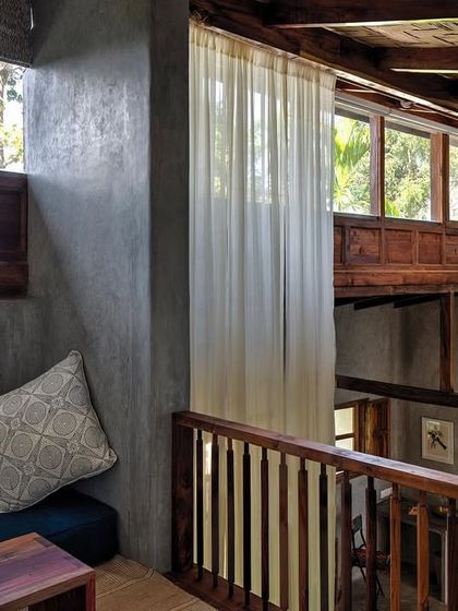 The mezzanine level in the Garden Suite's blue room, a cozy nook perfect for reading or as an extra sleeping space.