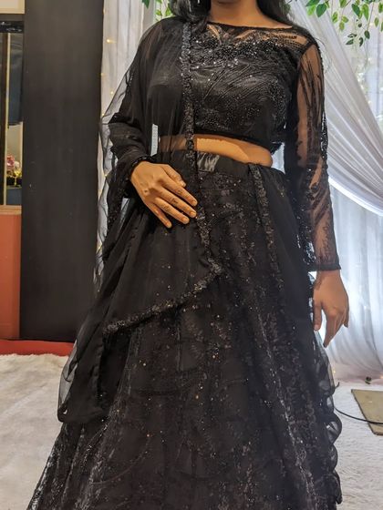This all-black beadwork lehenga is a chic and modern choice for a bridesmaid or wedding guest. It's available for rent.