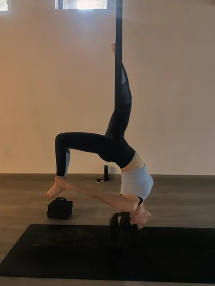 This beautiful supported bridge pose variation opens the chest and shoulders while building strength in the back. The hammock allows for a deeper, more restorative stretch.