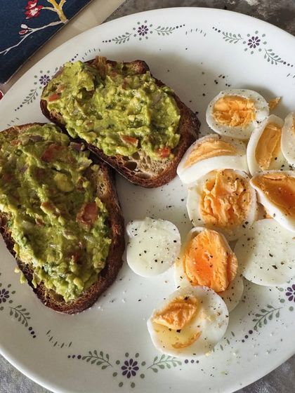 A beautiful plate of avocado toast and sliced boiled eggs. This anti-inflammatory meal is packed with healthy fats and protein to nourish you from within.