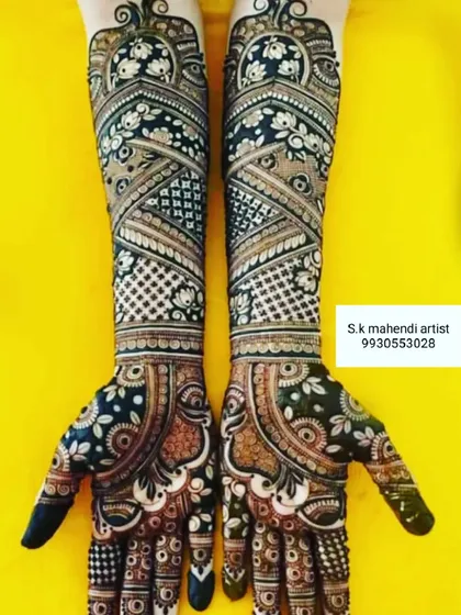 This design uses dark henna to create a bold and striking look. The pattern is a mix of modern geometric shapes and traditional floral motifs.