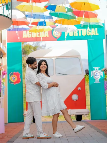 A fun, dynamic shot of the couple walking through a colorful, Portugal-themed alleyway. This set offers a unique and vibrant background for a pre-wedding shoot that feels like a European holiday.