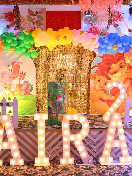 We bring the jungle to your party with our vibrant and detailed safari themes. This setup includes a stunning gold shimmer wall, custom character cutouts from The Lion King, large marquee letters, and a colorful balloon arch, creating an immersive experience for your child's celebration.