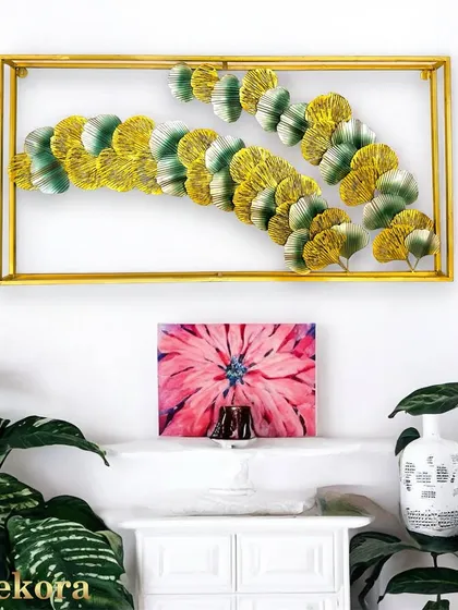 Encased in a sleek golden frame, this wall sculpture showcases a cascade of handcrafted ginkgo leaves. The blend of yellow and green tones creates a serene, nature-inspired piece that works beautifully in minimalist or modern homes.