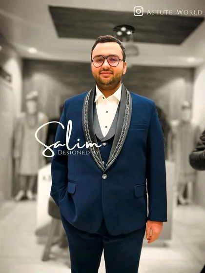 A client in a navy three-piece suit with embellished lapels. The fit is tailored to be sharp and modern, perfect for a wedding or formal party.