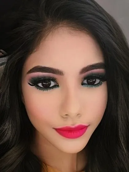 A close up on a bold party look. I created this dramatic eye with a sharp wing and blended liner, paired with a vibrant fuchsia lip to show my skill in creating sharp, impactful makeup that is perfect for evening events.