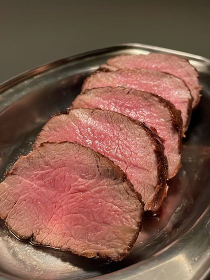 Slices of fillet steak, rested and ready for plating. Proper resting is crucial to ensure the meat is juicy and tender.