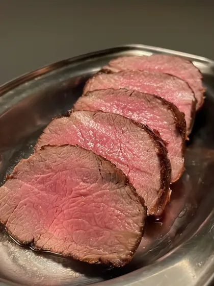 Slices of fillet steak, rested and ready for plating. Proper resting is crucial to ensure the meat is juicy and tender.