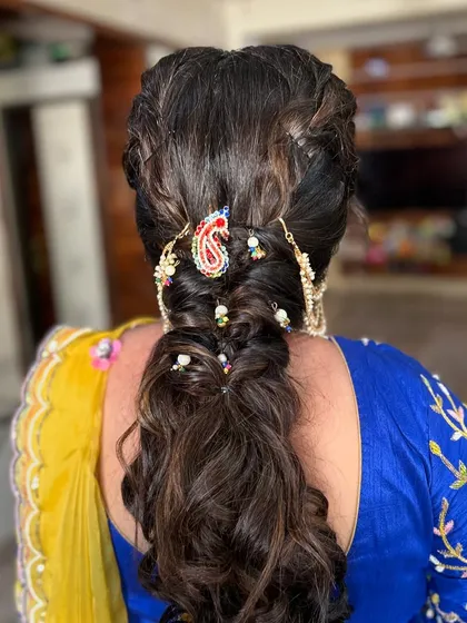 A traditional braided hairstyle with a modern twist. I used colorful threads and a traditional 'juda' pin to create this unique look.