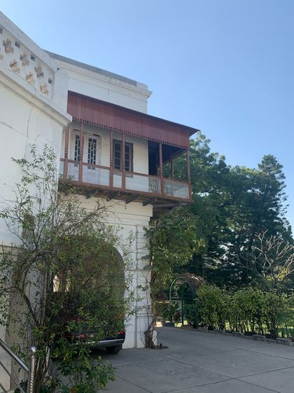 The beautifully restored timber balcony, adding an Indian element to an otherwise colonial-style bungalow.