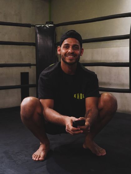 A happy member relaxing in the boxing ring. The smiles are as common as the sweat at Knox.