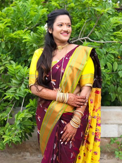 A candid-style shot of the model in a maroon and yellow saree. This pose creates a sense of natural elegance, perfect for a diverse modeling portfolio.