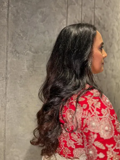 A side view of the natural curls, showing their soft and healthy bounce.