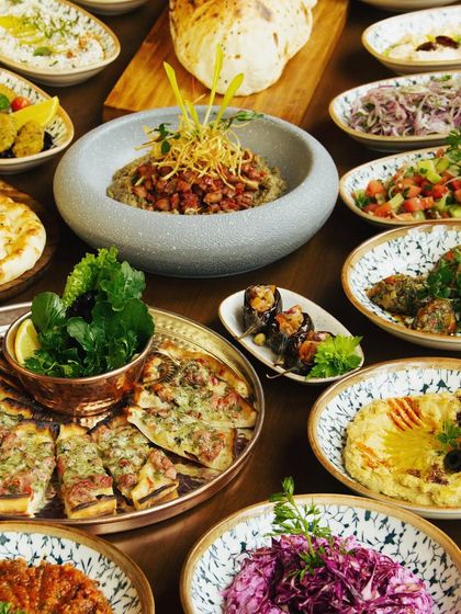 We offer an extensive menu of Turkish and Mediterranean delights. This grand spread showcases the variety we offer, from flavorful mezzes and salads to freshly baked breads and pizzas.