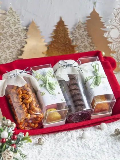 This Christmas hamper is designed for the ultimate chocolate and cookie lover. It features my double chocolate cookies, a bar cake, and spiced nuts, all packed in a festive red tray.