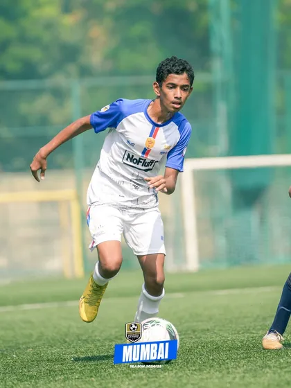 A young player dribbles with speed and control, showcasing the results of our ball mastery and agility drills.