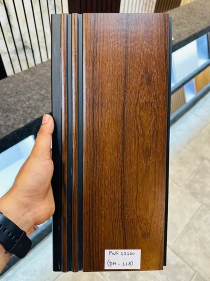 A dark walnut wood grain fluted panel. This is a popular choice for creating a sophisticated and modern look in offices or living rooms.