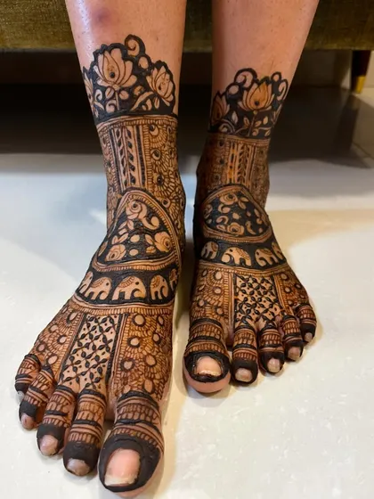 A full bridal feet design featuring rows of elephants and lotus flowers. The pattern is bold and beautiful, creating a stunning look.