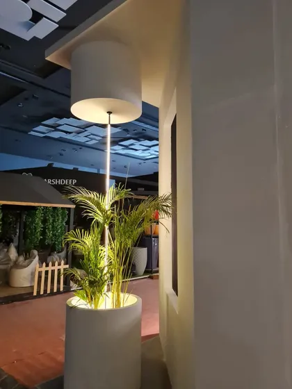 A close-up of the statement lighting feature at the entrance of our 2022 booth. This custom piece combines a planter with a vertical light, demonstrating our ability to create bespoke, integrated lighting solutions.