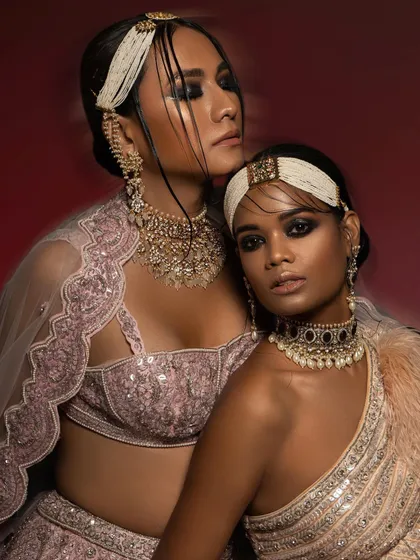 A powerful shot from a high-fashion editorial where I handled both the styling and art direction. The focus was on creating a dramatic, modern-ethnic look by layering intricate jewelry and using bold, smoky eye makeup against a rich, red backdrop.