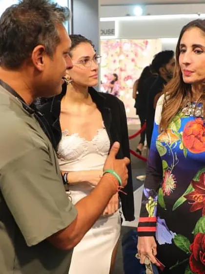 Engaged in an inspiring conversation with clients at our booth. Sharing the beauty of our luxurious wallpapers and fabrics is the best part of these events.