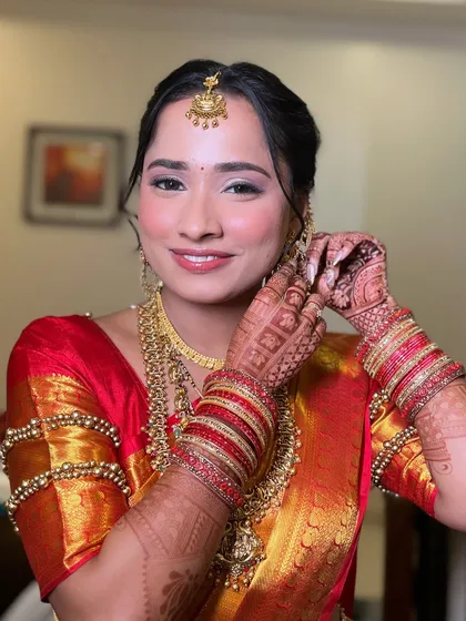 A candid moment as my South Indian bride adjusts her earring. Her makeup is designed to be fresh and natural, allowing her joy and excitement to shine through.