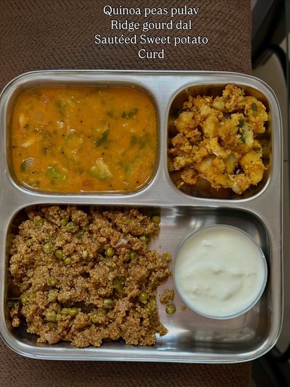 A wholesome meal of quinoa peas pulav, ridge gourd dal, sautéed sweet potato, and curd. This is a great example of a balanced vegetarian meal.