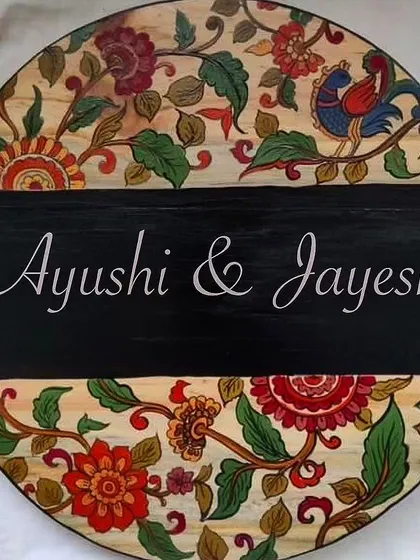 A custom hand-painted circular nameplate featuring a traditional Kalamkari floral design. Our nameplates are our bestsellers, and we love working with clients to create a unique welcome for their homes.