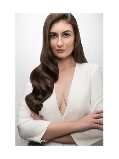 This portrait for a hair beauty campaign showcases a powerful, confident look. My retouching process ensures that while the image is commercially polished, the model's expression and skin texture remain authentic and strong.