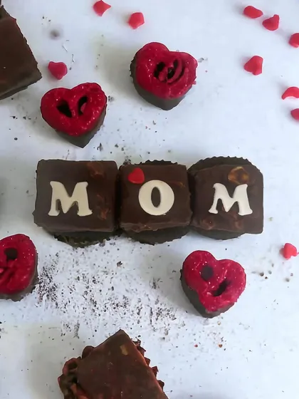 For Mother's Day, I created these special chocolate-glazed brownie bites. They are fudgy, rich, and can be personalized with letters to spell out 'MOM' for a truly unique and delicious gift.