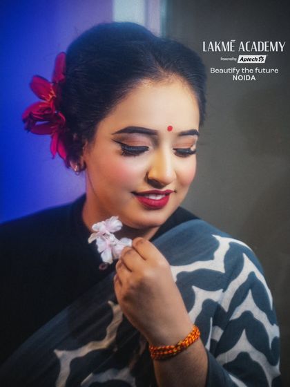 A beautiful retro-inspired look, featuring classic winged eyeliner, a red bindi, and a soft, romantic hairstyle.