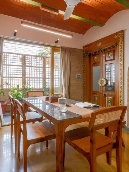 The dining room, with its beautiful wooden furniture and jack-arch roof, is a testament to craftsmanship.