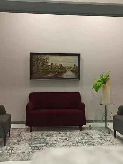The reception area at Shiva Group's head office, designed to make a lasting first impression. I used custom grey mouldings to create a classic archway, framing a comfortable and elegant seating arrangement. This space balances professional decor with a welcoming atmosphere for visitors.