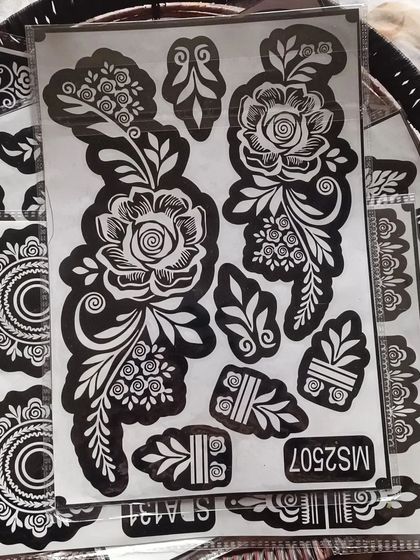 A close-up of the large rose stencil. You can see the fine details that will make your henna art look professionally done.