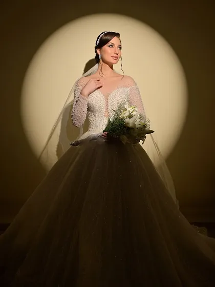 Another stunning shot under the spotlight, this time with the bride holding her bouquet.