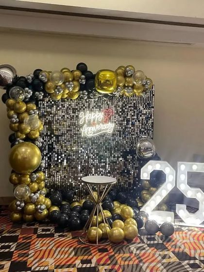 A wide shot of the 25th-anniversary decor in a party hall, showing how it creates a perfect focal point.