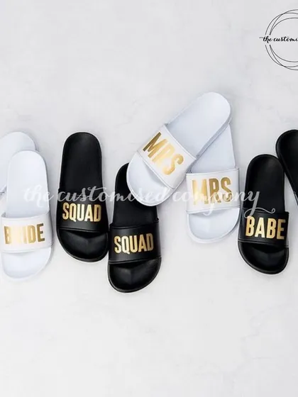 Sliding through life with your own personal touch. These comfy slides are available in black and white and can be customized for the "Bride," "Mrs," "Squad," or "Babe."
