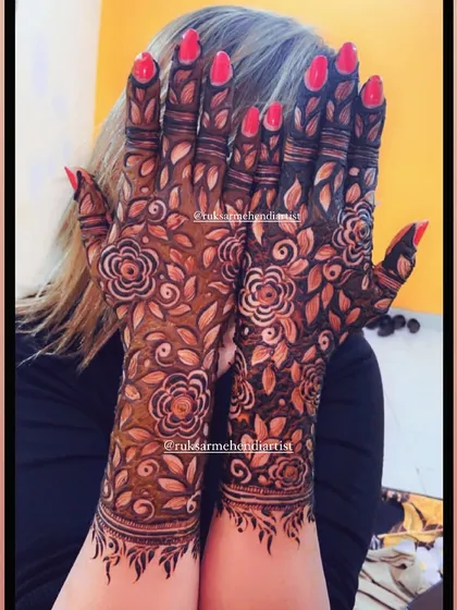 A client happily showing off her dark floral mehendi stain.