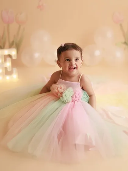 Happy First Birthday to this little ray of sunshine. Her joyful laugh and the pastel rainbow dress make this a perfect cake smash alternative for a one-year-old's photoshoot.