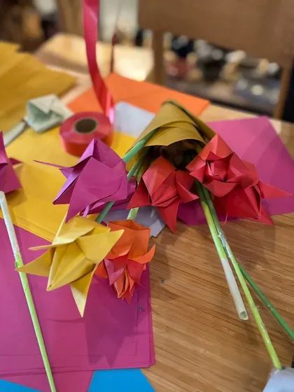 A close-up shot of colorful, handcrafted origami flowers made during one of our workshops. We provide all the paper and materials, guiding you step-by-step to create these delicate and beautiful paper crafts.