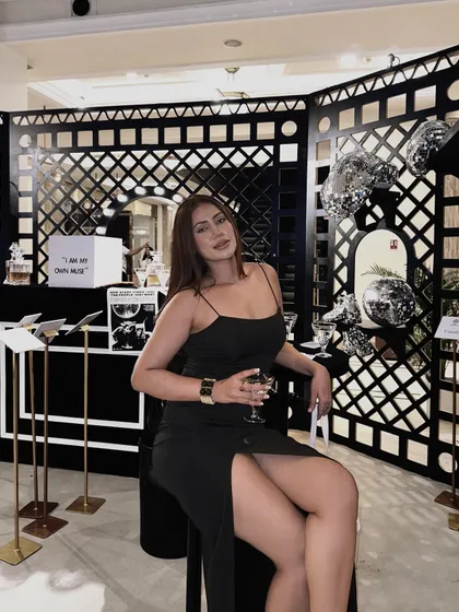 Posing at a fashion event in the elegant black gown, a timeless and classic look.